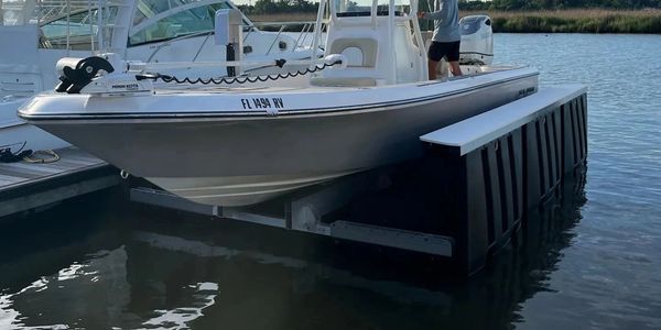 Guardian Floating Boat Lift with Center Console Boat lifted out of water in a Florida Marina 