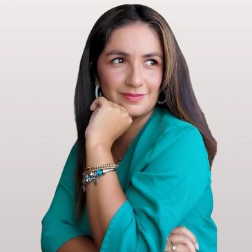 Woman in teal blouse with thoughtful expression and bracelets.