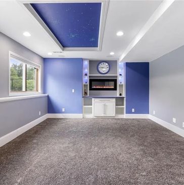 Finished basement with fireplace, entertainment center & star ceiling