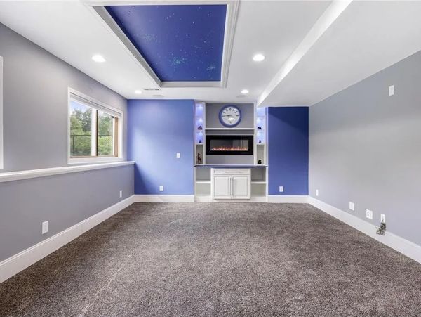 Complete finished basement with fireplace, star ceiling and storage