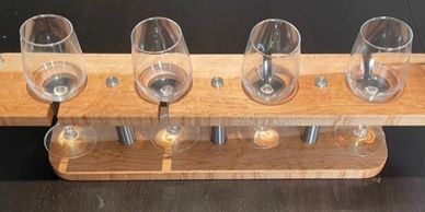Wooden wine glass holder with four glasses.