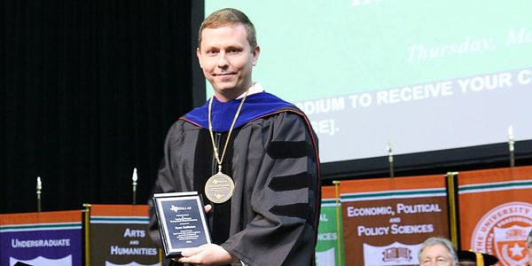 Photo of Dr. McMahan receiving his Provost's Award for Faculty Excellence in Undergraduate Research 