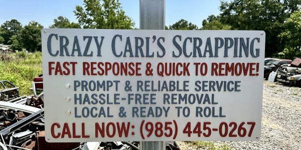 Sign for Crazy Carl's Scrapping with contact info.