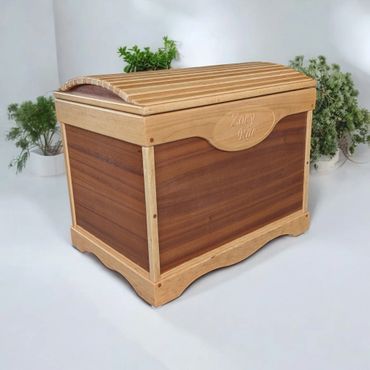 Wooden storage chest with decorative plants in the background.
