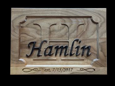 Wooden plaque with 'Hamlin' and establishment date engraved.