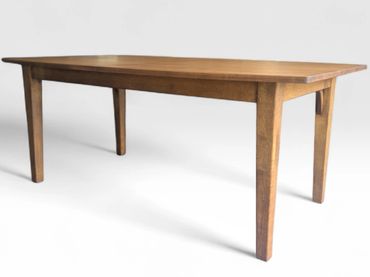 A simple wooden rectangular table with four legs.