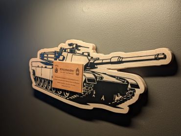 Wooden tank wall art with a plaque.