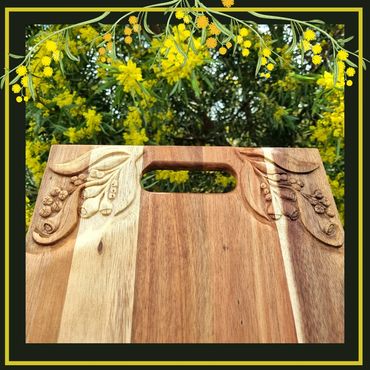 Hand carved Acacia grazing board with Australian theme of leaves and gumnuts 