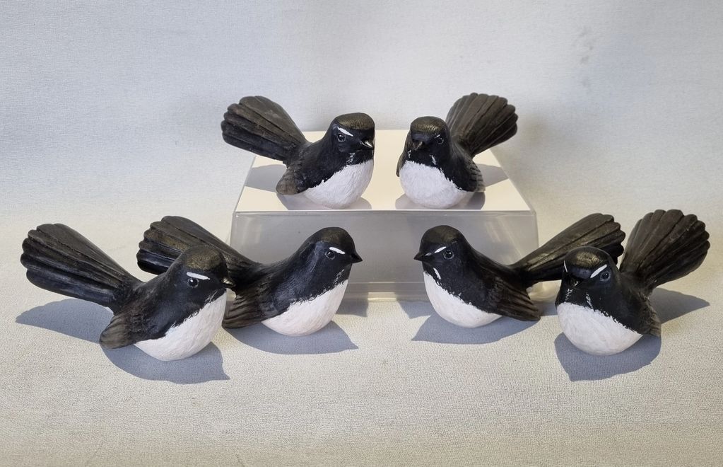 Carved and painted flock of Willywagtails 