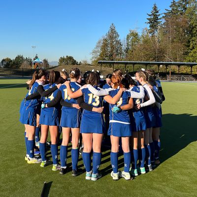 Athletes in team huddle