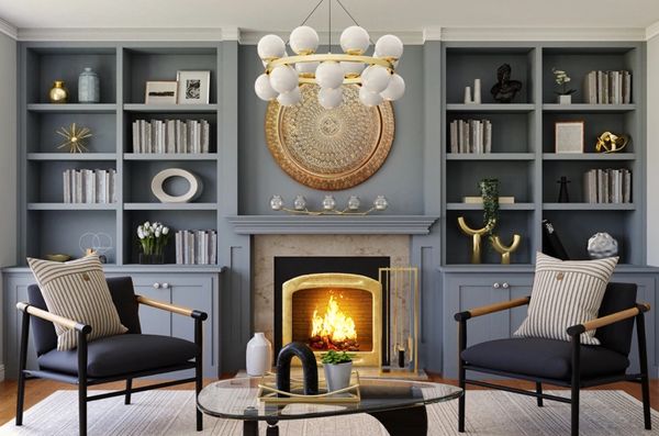 Luxury custom built bookcases surrounding fireplace in slate blue.