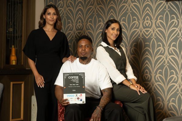Three people posing with Coffee Magazine Awards plaque.