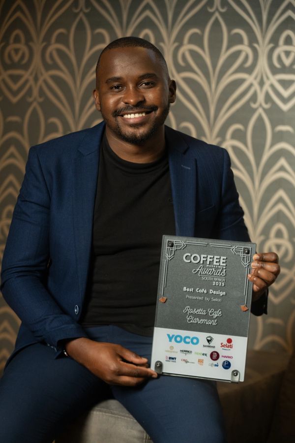 Man smiling and holding a Coffee Magazine Awards plaque.