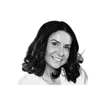 Smiling woman with shoulder-length hair in black and white portrait.