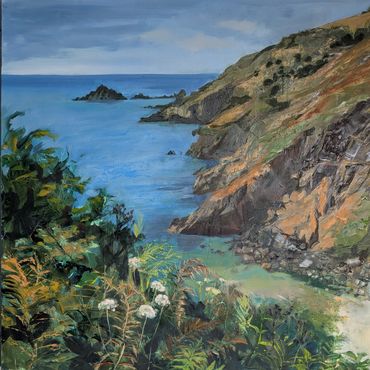 Coastal landscape with cliffs, blue sea, and lush greenery.