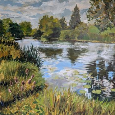 A serene river landscape with lush greenery and reflections in the water.