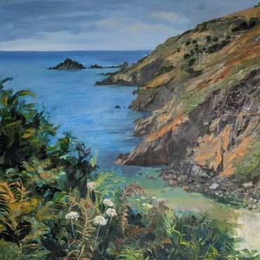 Coastal landscape with cliffs, blue sea, and lush greenery.