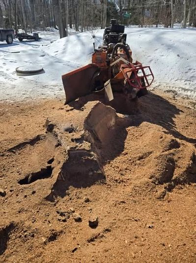 Stump grinding working on a large tree stump in Sussex County, NJ