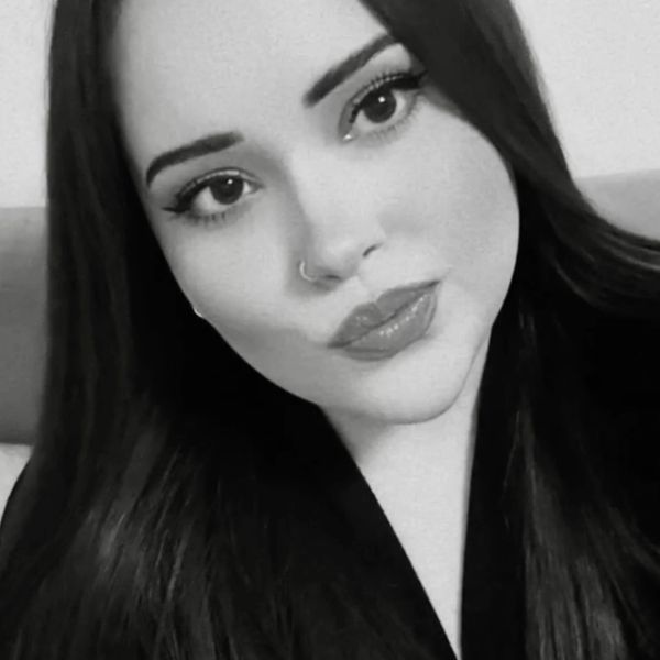 Black and white close-up portrait of a woman with long hair.