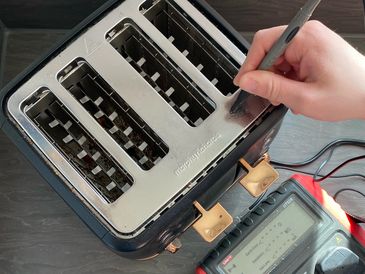 Morphy Richards four-slot toaster being tested with an earth probe.