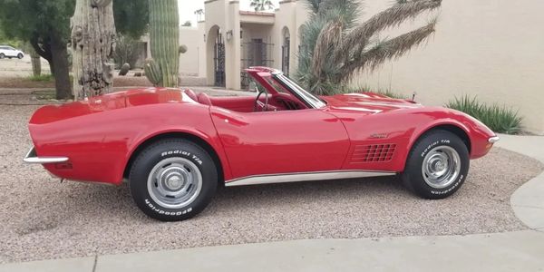 Side profile of a 1971 Corvette Stingray Convertible in factory 973 Mille Miglia Red