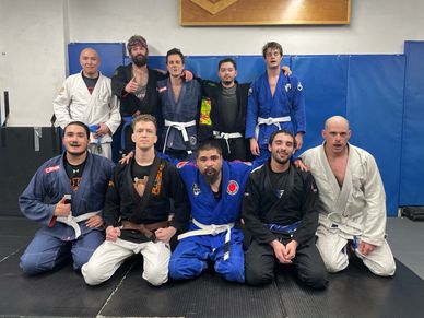 a team group photo after Brazilian Jiu Jitsu with smiling members in gi