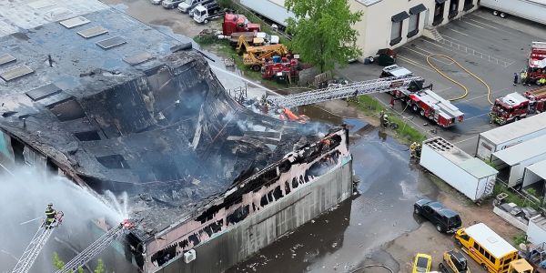 Firefighters extinguishing a large building fire.