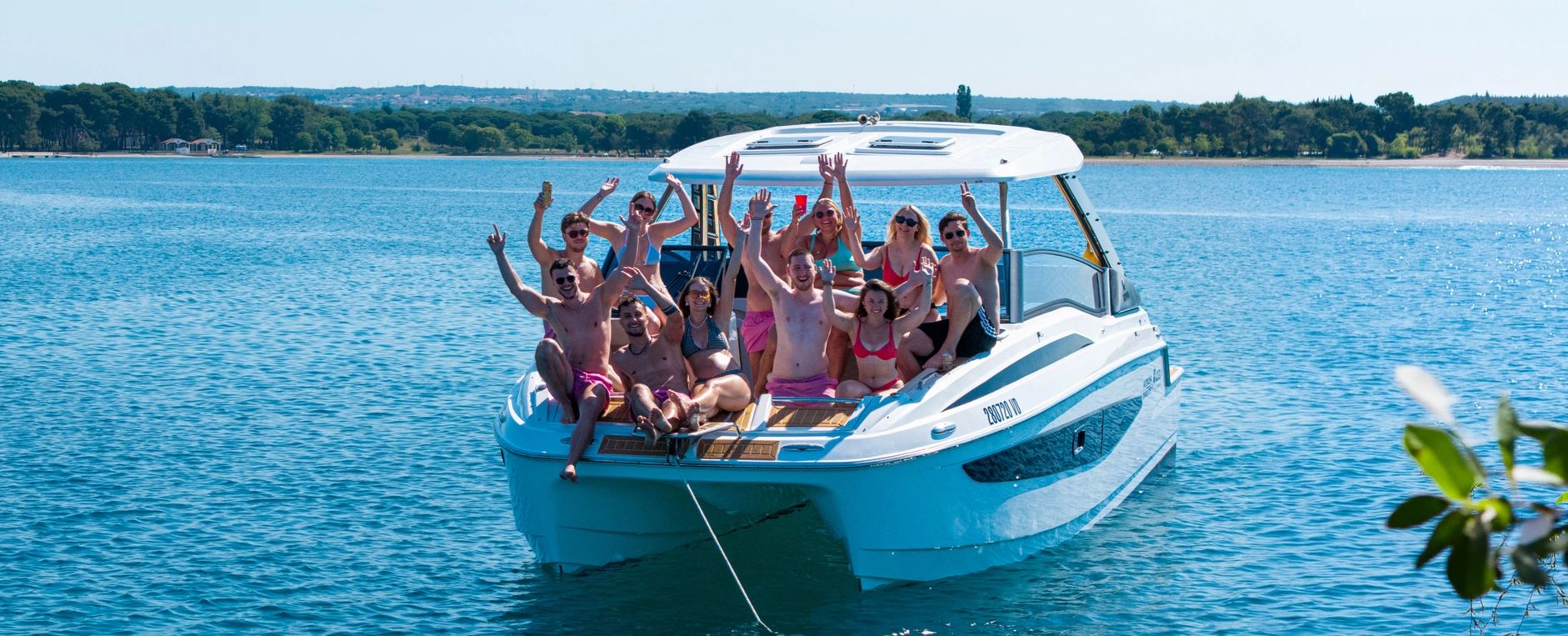 Group of friends enjoying a boat party on a sunny day.