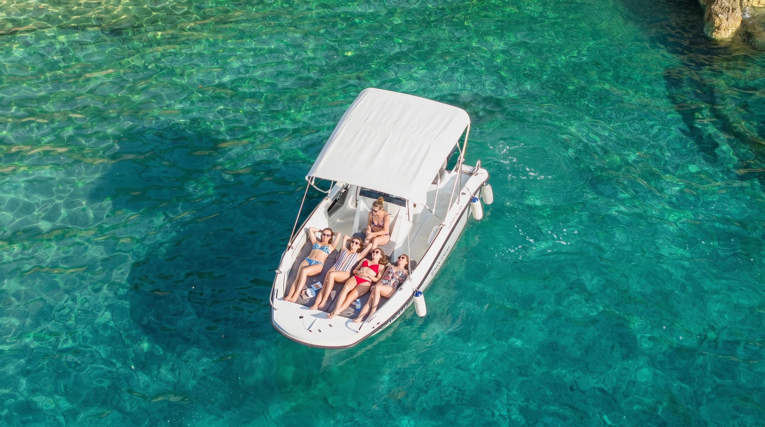 Group of girls relaxing on Andromeda 635 100HP in Pula. Boat is rented from Andromeda Boat Rent Pula