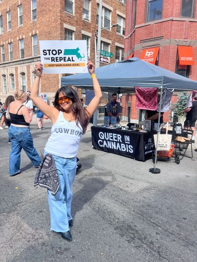 Woman holding sign at cannabis rally.
