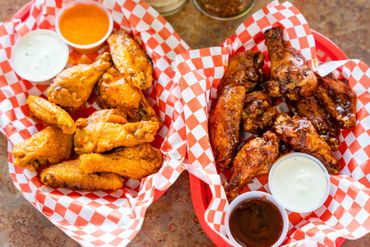 two types of chicken wings with dips 