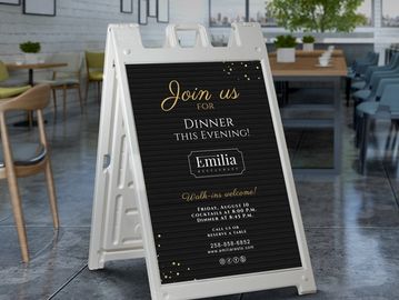 A stylish sidewalk sign inviting guests to dinner at Emilia restaurant this evening.