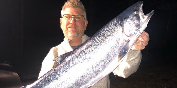 Captain with huge Steelhead Trout 