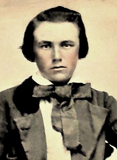 Vintage portrait of a young man with a serious expression and a large bow tie.
