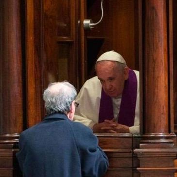 Pope Francis listening to a confession in a traditional confessional booth.