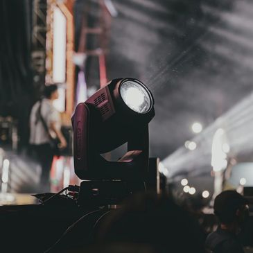 Stage spotlight illuminating a live concert scene.