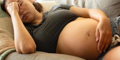 A young pregnant woman resting on a couch