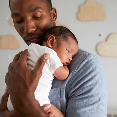 A young father holding his infant son