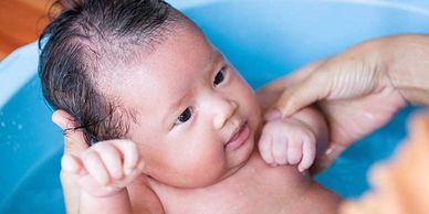 Infant in a blue bath tub