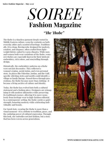 A woman models a traditional embroidered thobe in a desert setting, symbolizing heritage and culture.