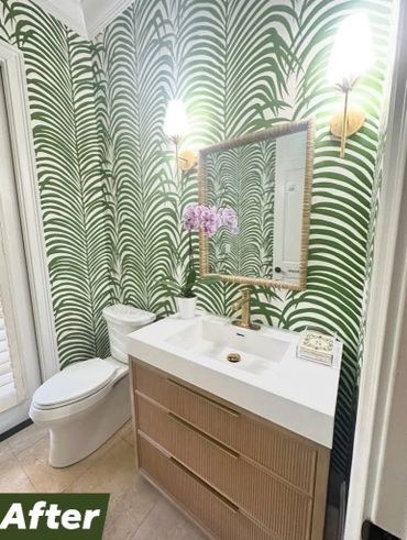 Bathroom with tropical wallpaper, modern sink, and wooden vanity.