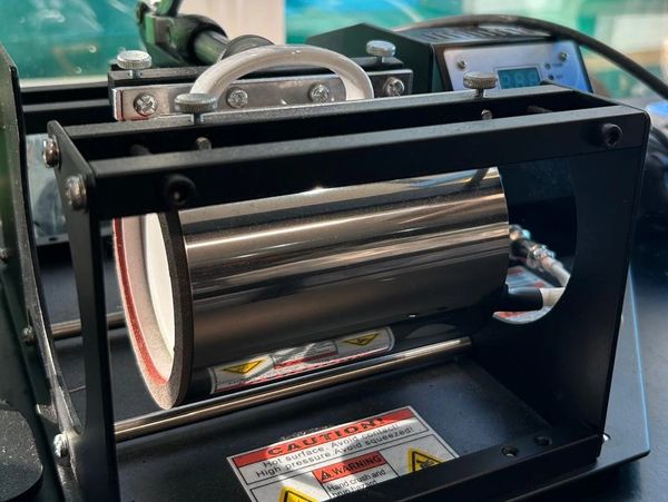 Close-up of a heat press machine used for sublimation printing.