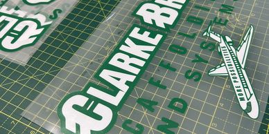 Vinyl decals for Clarke Bros on a cutting mat.