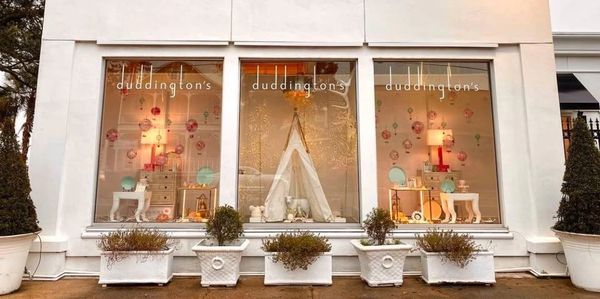 Elegant storefront with festive decorations and a cozy tent display.