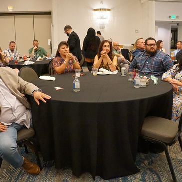 People seated around a table at a social event or meeting.