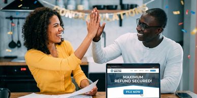 Couple high-fiving at a desk with a laptop displaying "MAXIMUM REFUND SECURED!".