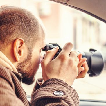 Man filming with SLR camera