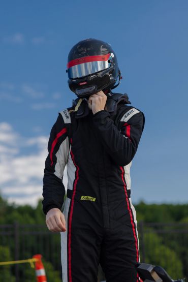 Racer adjusting helmet before race.