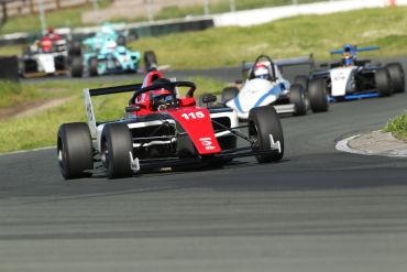 Race cars competing on a track curve.
