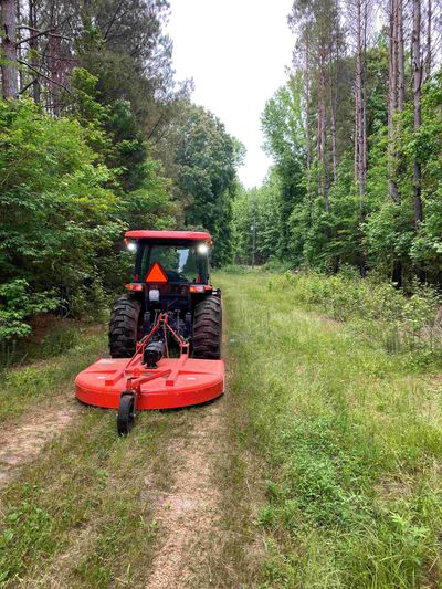 Kubota and John Deere bush hogging grass, pasture, and hunting land properties. Brush Hogging land.